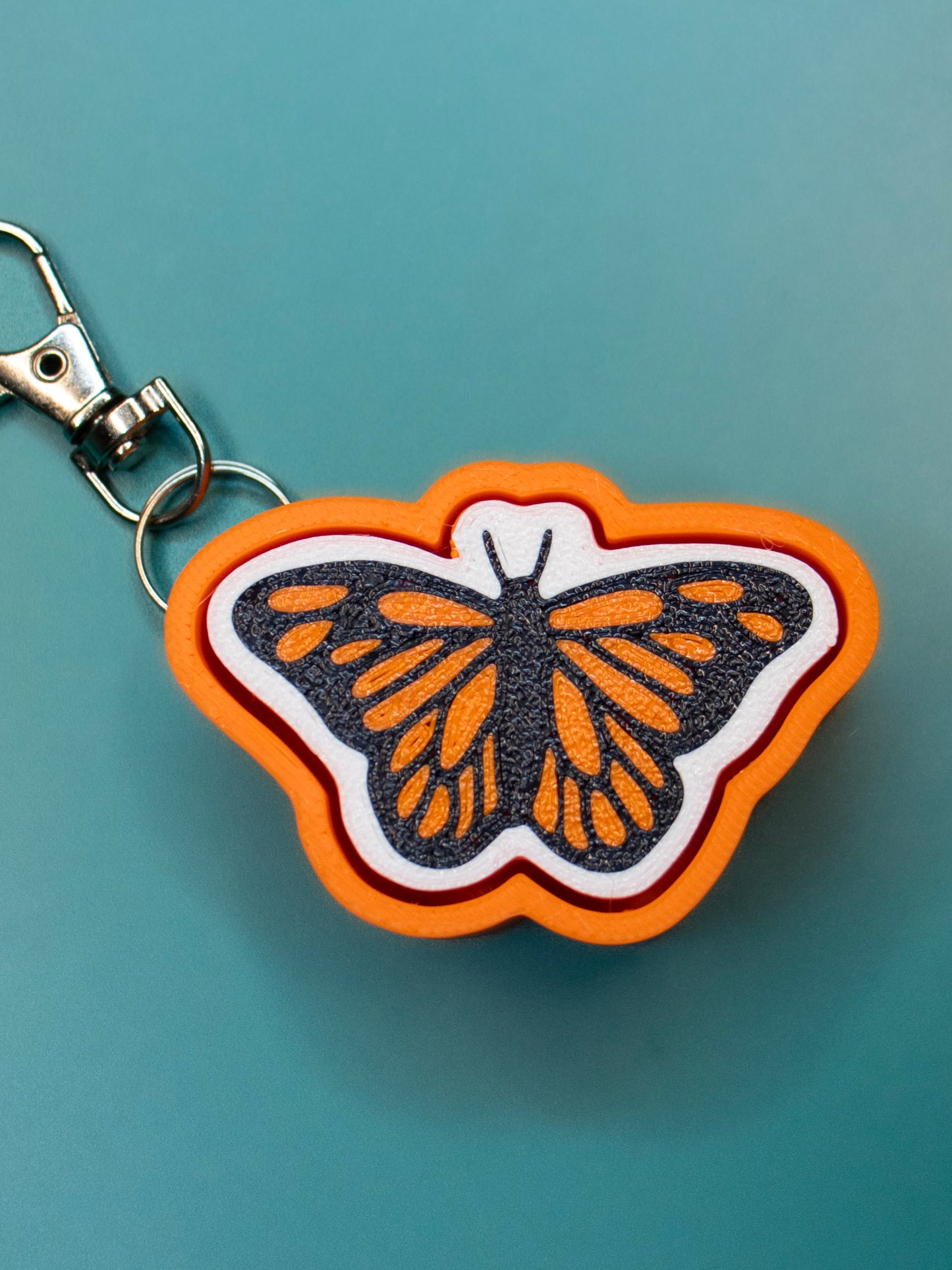 Print Pop Butterfly Keychain on teal background