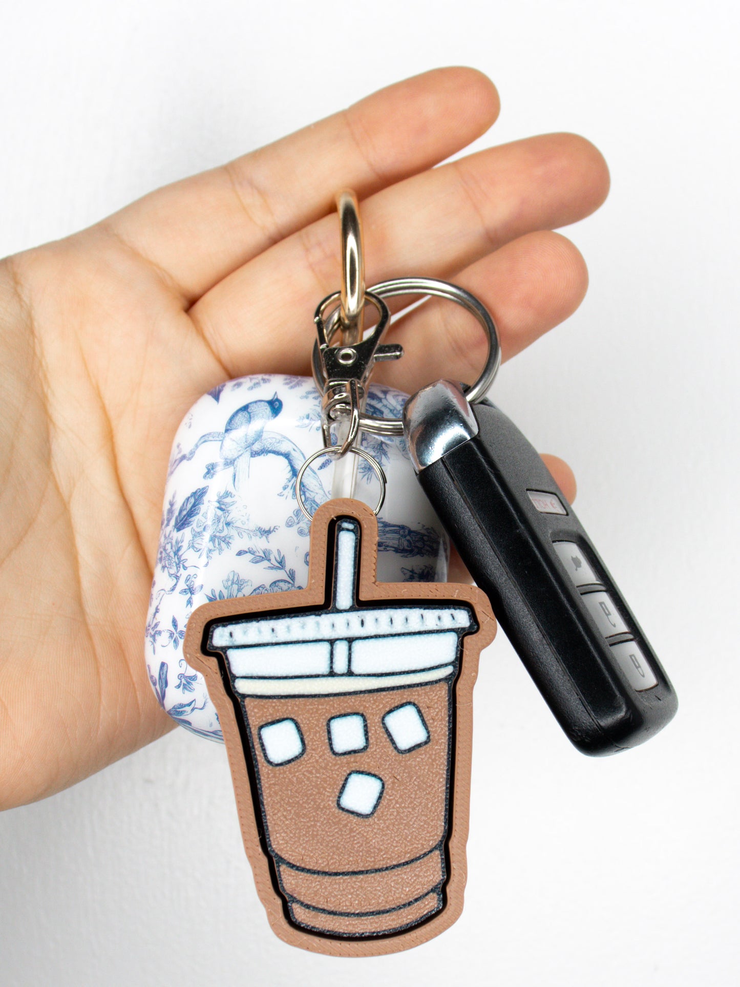 Iced coffee clicky fidget keychain on set of keys white background