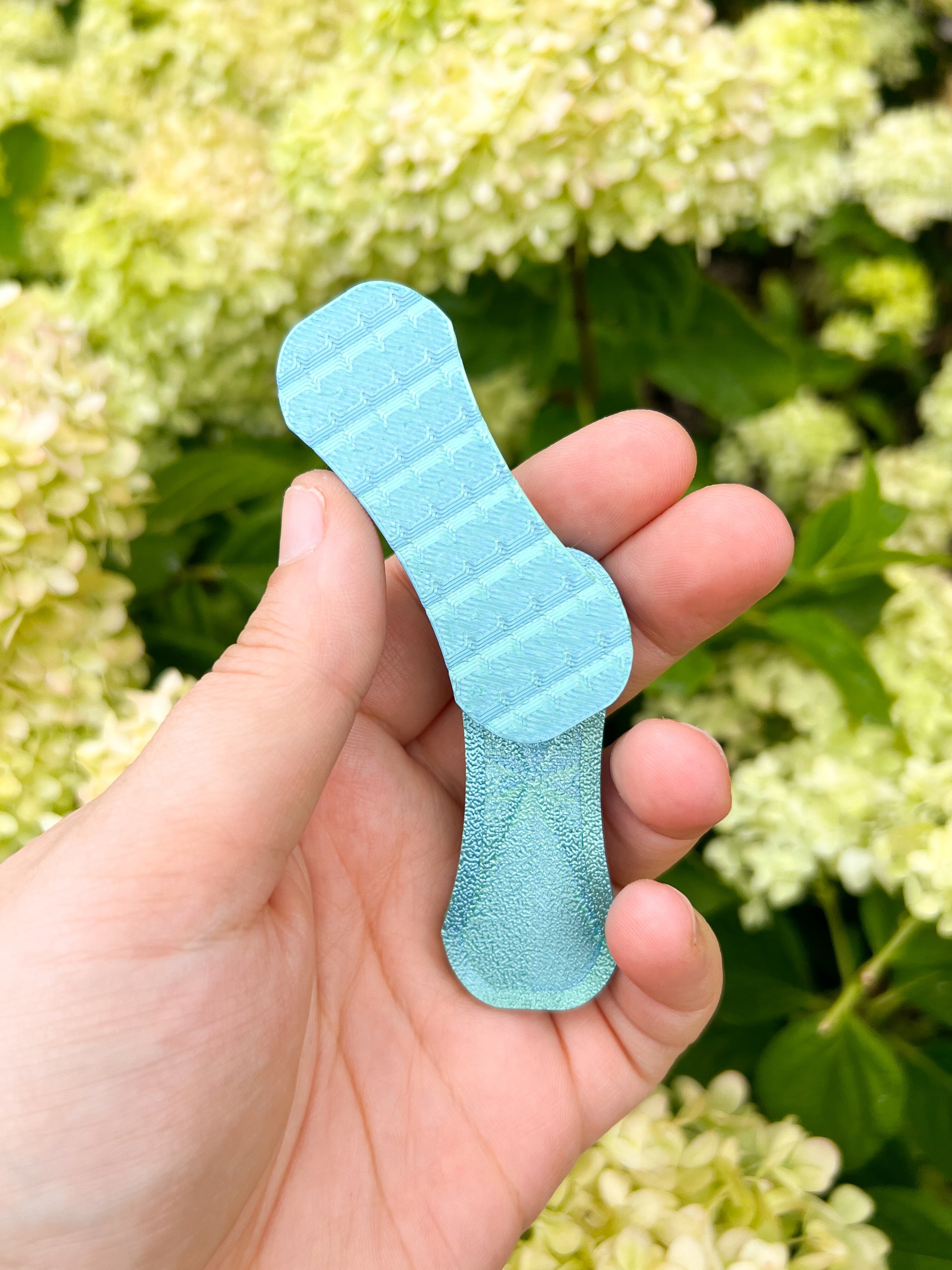 Teal blue magnetic fidget slider in hand print pop creations