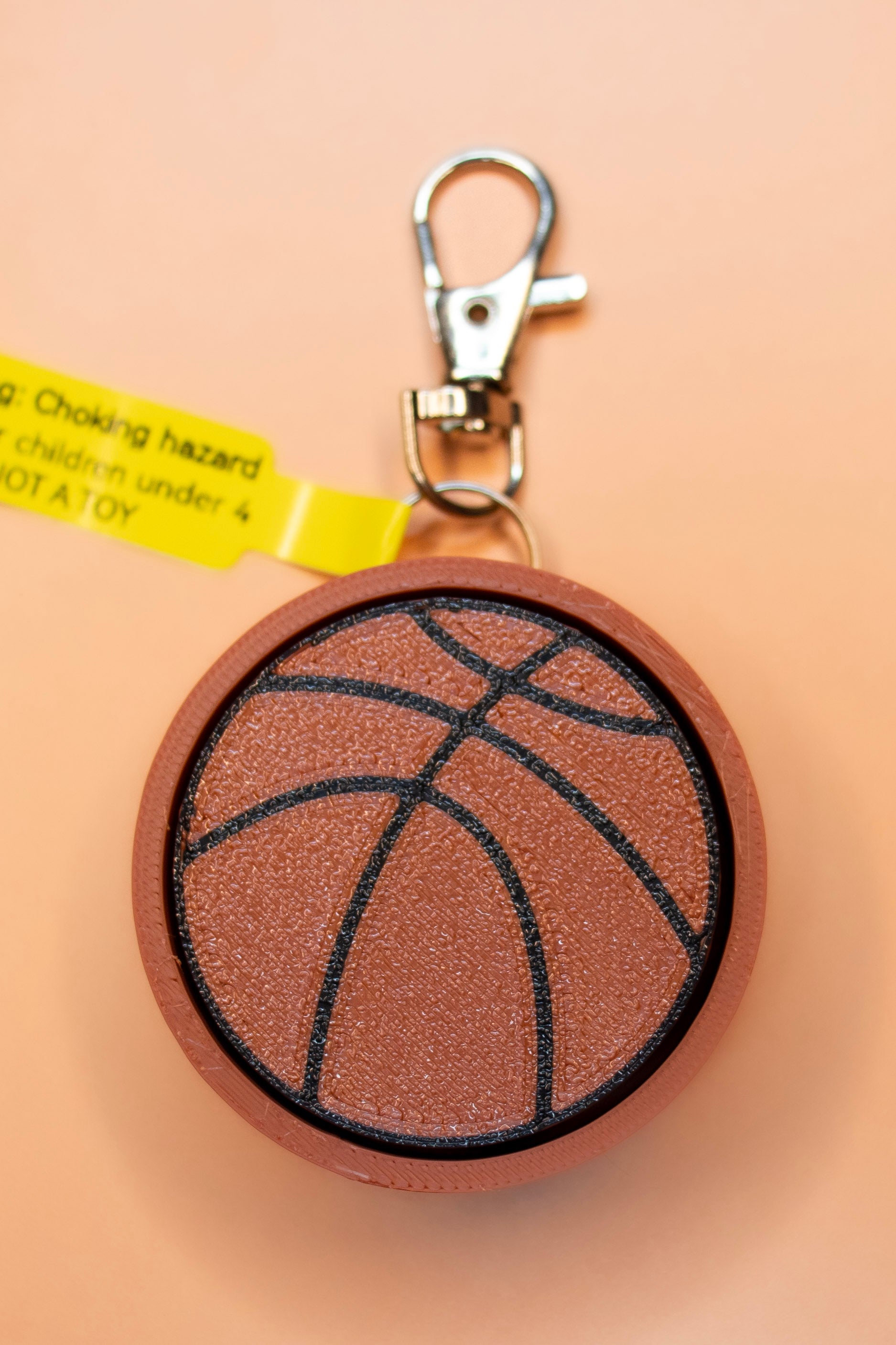 Backetball keychain on orange background