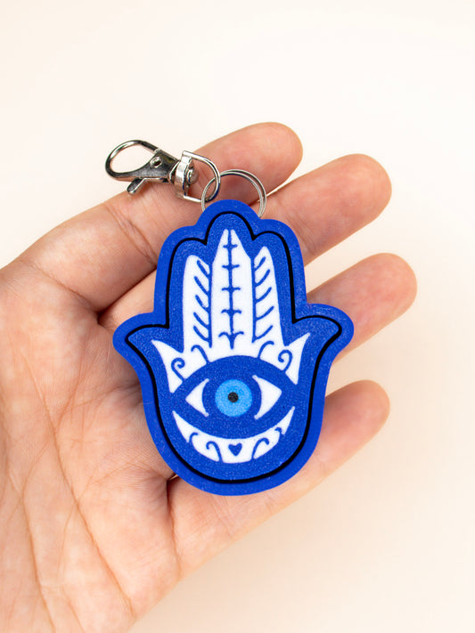 Evil eye clicky keychain in hand