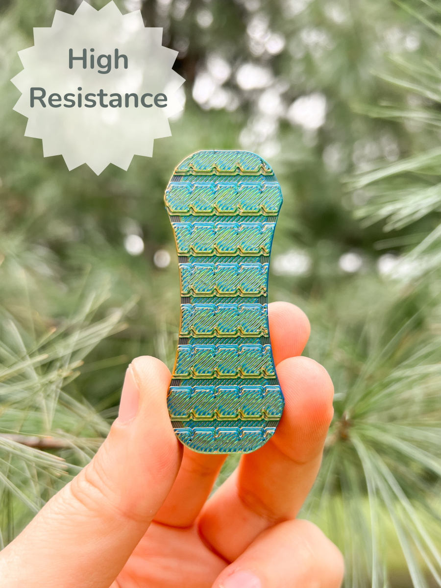 Print Pop Fidgets High Resistance Magnetic Fidget Slider in color dragon scales in hand on green background