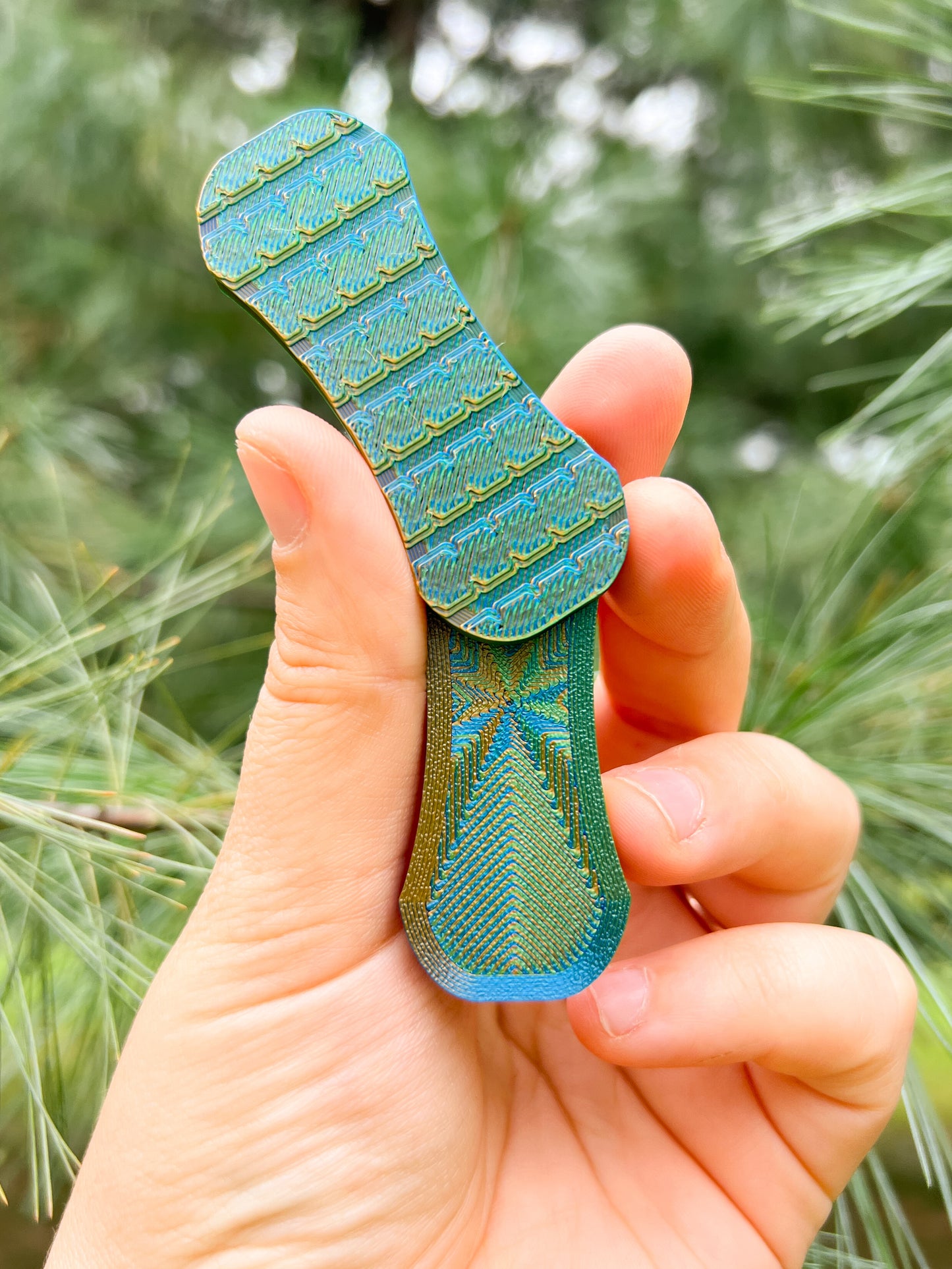 Print Pop Fidgets High resistance magnetic fidget slider in hands on a green background