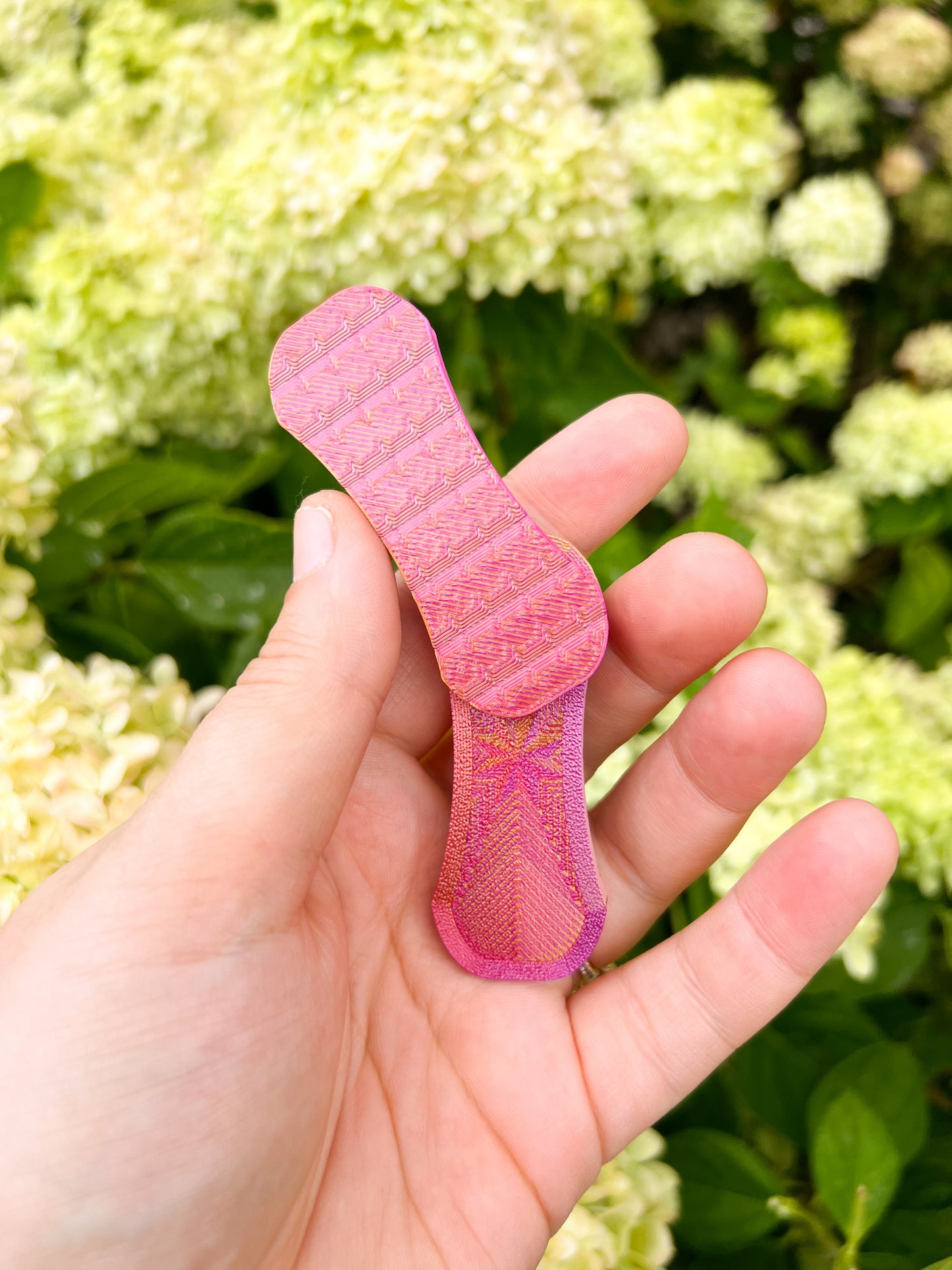 Pink magnetic fidget slider in hand top view