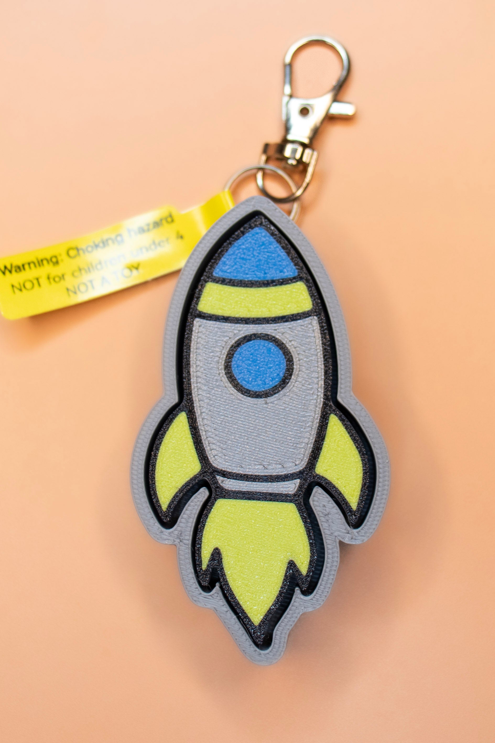 Rocketship keychain on orange background