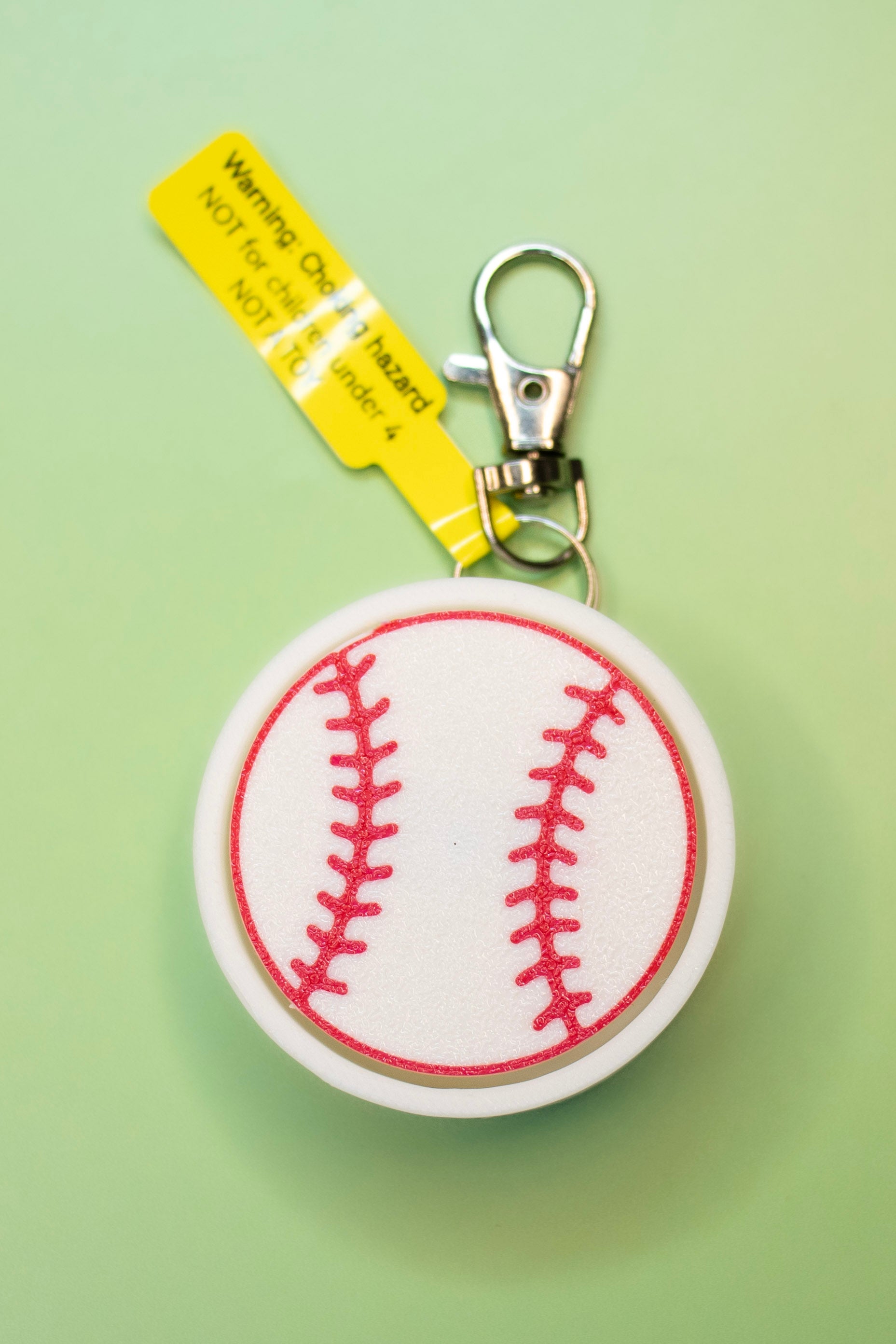 softball clicky ketchain on green background