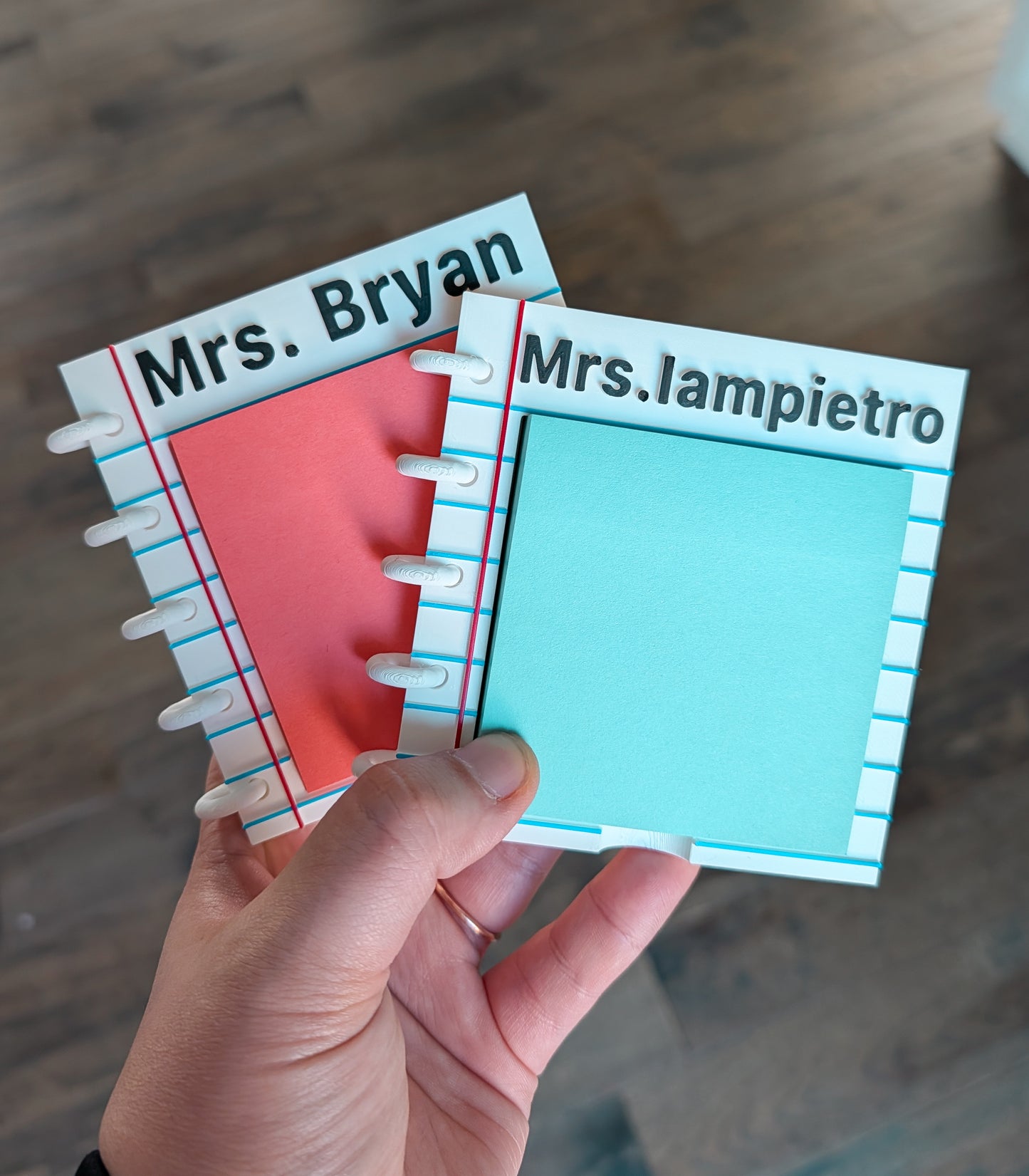 Two custom sticky note holders shaped like a notebook with names Mrs. Bryan and Mrs. Iampietro. 